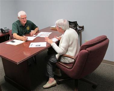 Seniors Vs Crime together at a desk